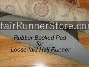 Rubber backed pad for a loose-laid hall runner